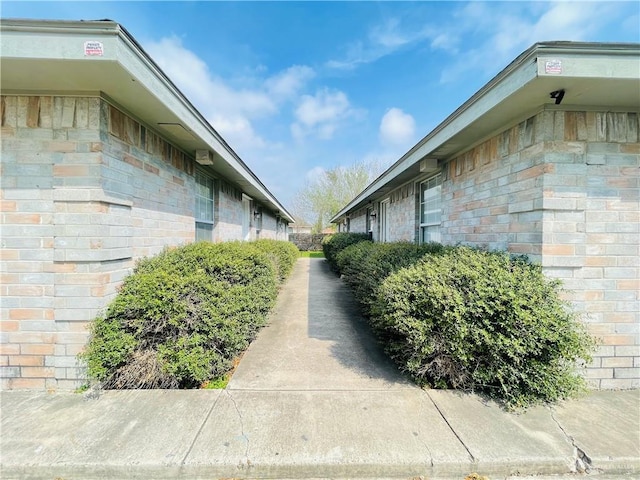 view of property exterior featuring brick siding