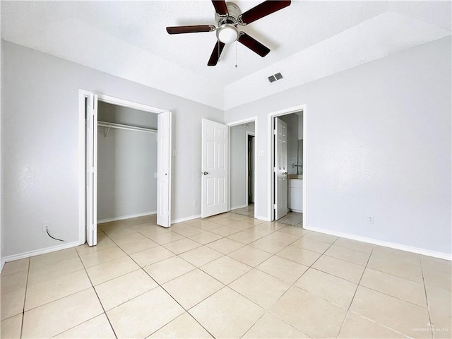 unfurnished bedroom with light tile patterned floors, ceiling fan, visible vents, and baseboards