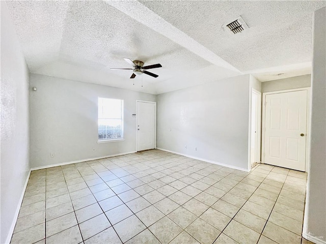 spare room with baseboards, light tile patterned floors, visible vents, and a ceiling fan