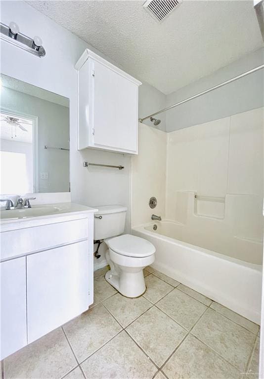 bathroom with visible vents, toilet, tile patterned flooring, a textured ceiling, and shower / washtub combination