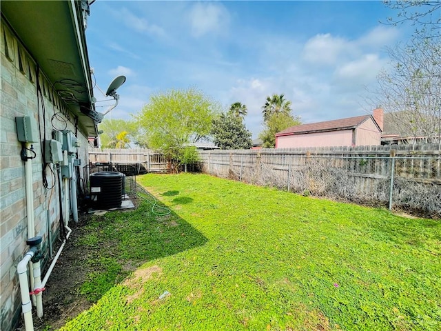 view of yard featuring a fenced backyard and central air condition unit