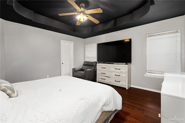 3608 Kingsborough Ave, Mcallen, TX 78504 - bedroom featuring a tray ceiling, baseboards, dark wood-style floors, and ceiling fan