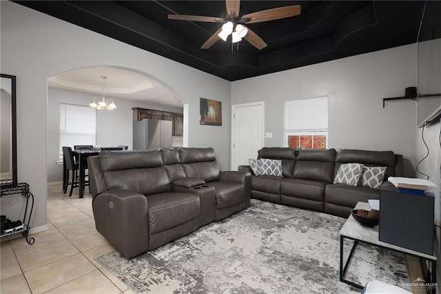 3608 Kingsborough Ave, Mcallen, TX 78504 - living room featuring a tray ceiling, arched walkways, light tile patterned floors, ceiling fan, and a chandelier