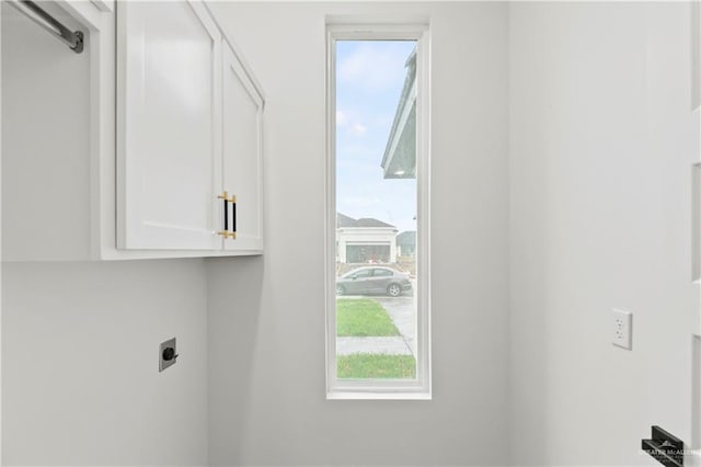 laundry area featuring cabinets and electric dryer hookup