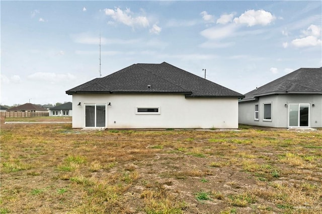 rear view of property featuring a yard