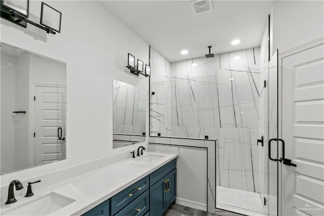 bathroom featuring vanity and an enclosed shower