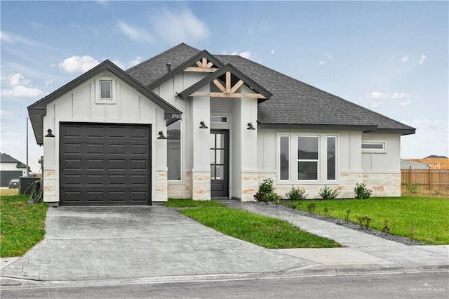 view of front facade featuring a front yard and a garage