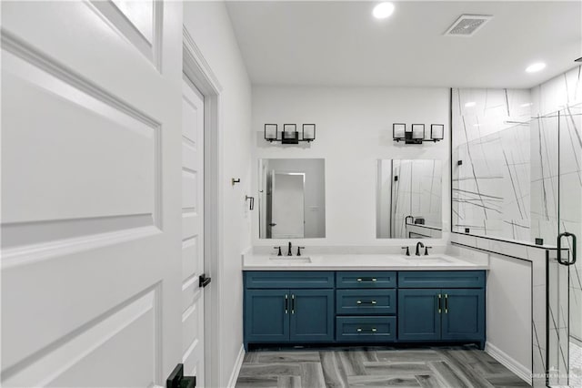 bathroom featuring vanity, parquet flooring, and walk in shower