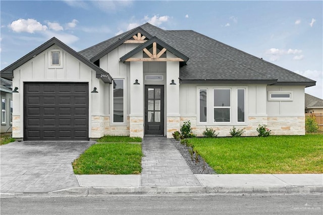 view of front of property with a garage and a front lawn