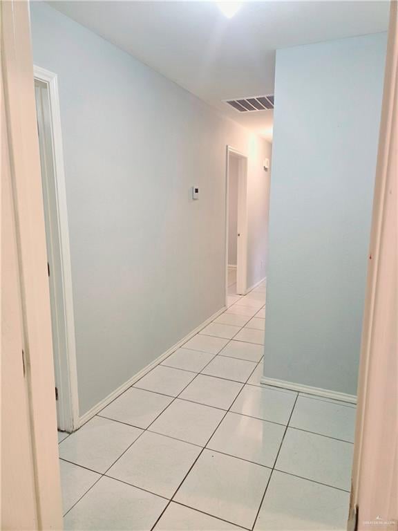 hall featuring light tile patterned flooring