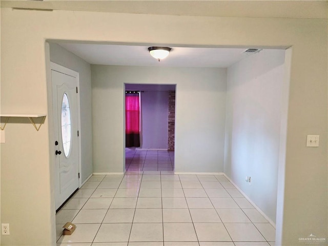 entryway with light tile patterned flooring