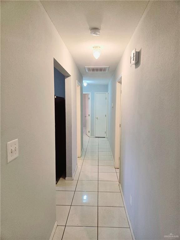 corridor with light tile patterned floors