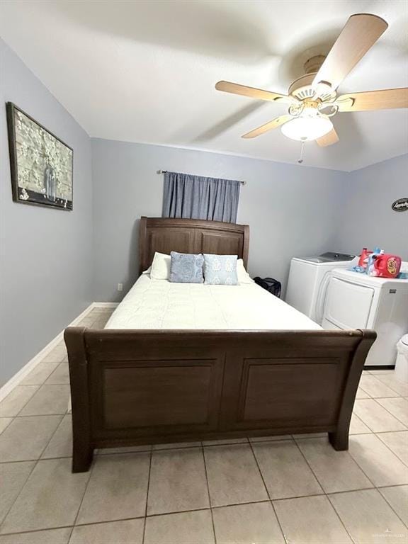 bedroom with light tile patterned floors, lofted ceiling, a ceiling fan, independent washer and dryer, and baseboards