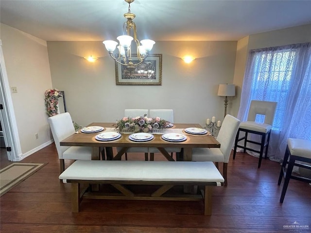 dining space with a chandelier, wood finished floors, and baseboards