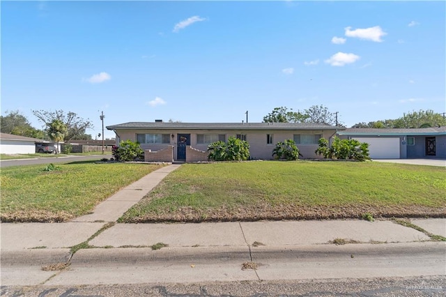 single story home with a front yard and a garage