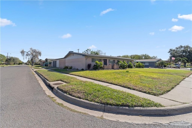 ranch-style home with a front lawn