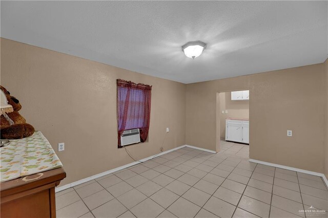 spare room featuring light tile patterned floors and cooling unit