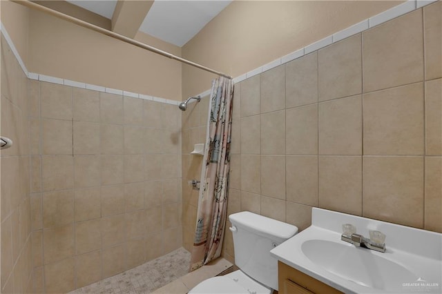 bathroom with a shower with curtain, vanity, and tile walls