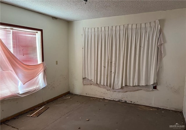 1005 S Nebraska Ave, Weslaco, TX 78596 - spare room with a textured ceiling