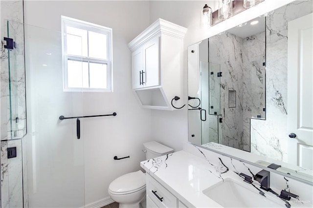 full bathroom featuring a marble finish shower, toilet, and vanity