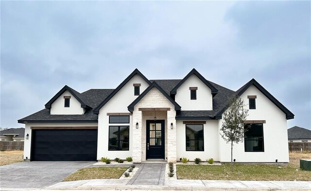 view of front of property with a garage and a front lawn