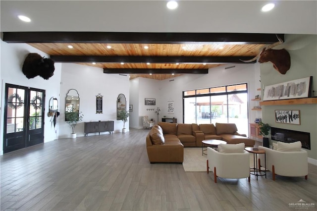 living room with beamed ceiling, french doors, and hardwood / wood-style flooring