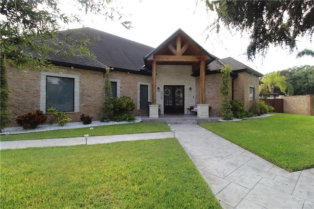 view of front of house featuring a front yard and french doors