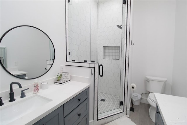 bathroom featuring vanity, toilet, and walk in shower