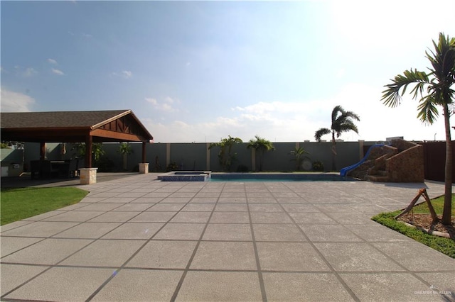 view of pool with a gazebo, a patio area, and a water slide