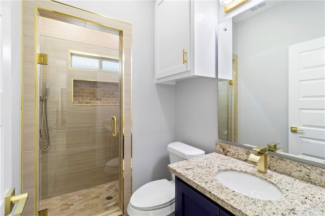 bathroom with vanity, an enclosed shower, and toilet