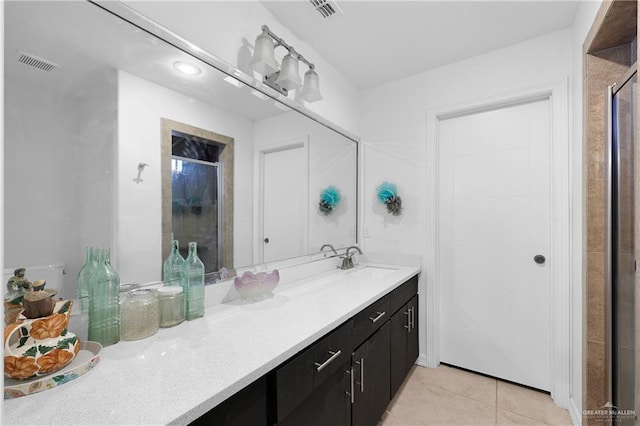 bathroom with vanity, an enclosed shower, and tile patterned flooring