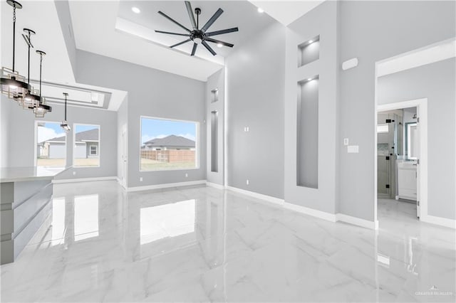 living room featuring baseboards, ceiling fan, marble finish floor, a high ceiling, and recessed lighting