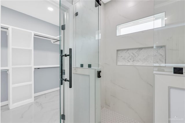 bathroom featuring marble finish floor, a marble finish shower, and recessed lighting