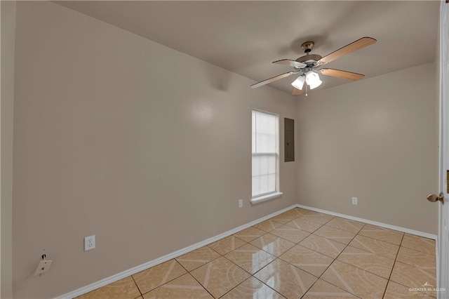 tiled empty room featuring ceiling fan and electric panel