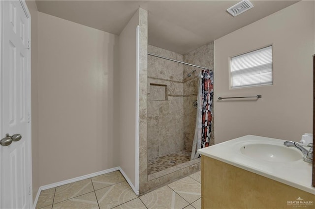 bathroom featuring vanity, tile patterned floors, and curtained shower