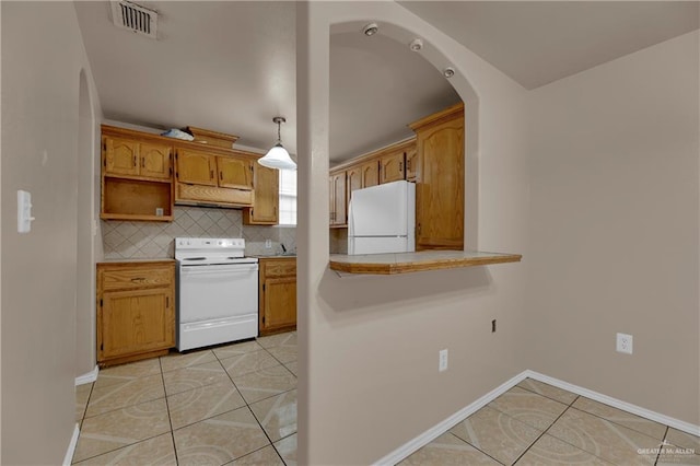 kitchen with decorative backsplash, light tile patterned floors, hanging light fixtures, and white appliances