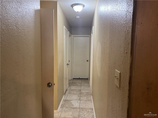 907 W 7th St, Weslaco, TX 78596 - hall with a textured wall and light tile patterned floors