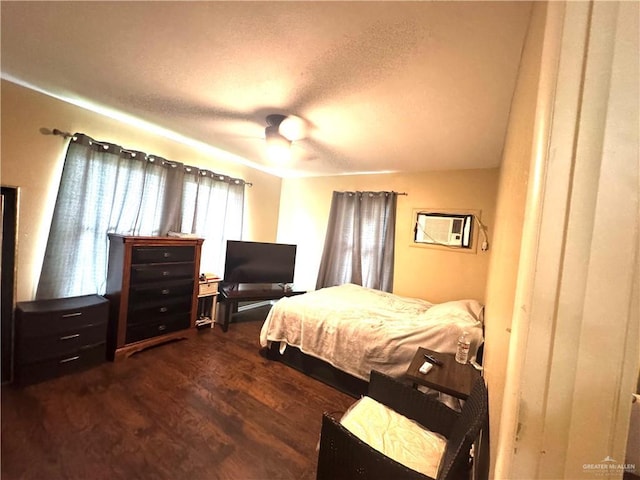 907 W 7th St, Weslaco, TX 78596 - bedroom featuring dark wood-style floors, a textured ceiling, and ceiling fan