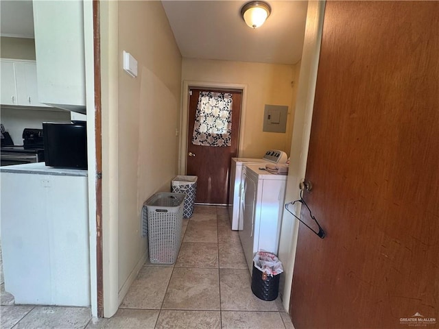 907 W 7th St, Weslaco, TX 78596 - washroom with electric panel, washing machine and clothes dryer, and light tile patterned flooring