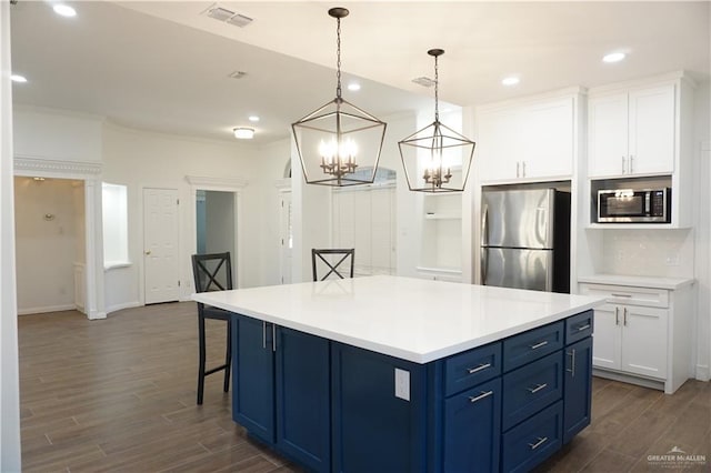 kitchen with blue cabinetry, stainless steel appliances, white cabinetry, and a kitchen island