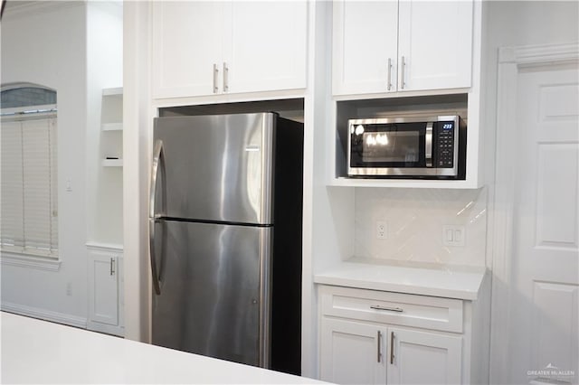 kitchen with stainless steel appliances and white cabinetry