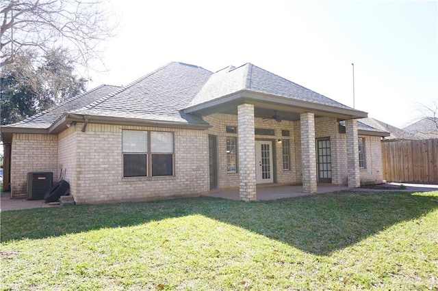 back of house featuring a lawn, a patio, and central AC