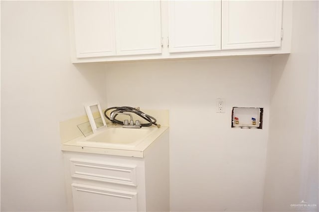 laundry area featuring cabinets, washer hookup, and sink