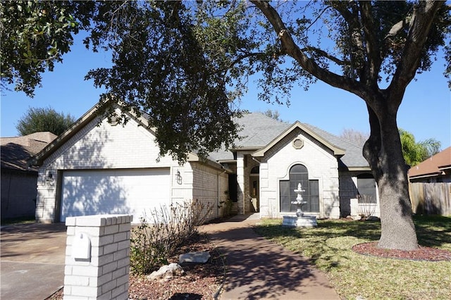 view of front of home with a front lawn and a garage