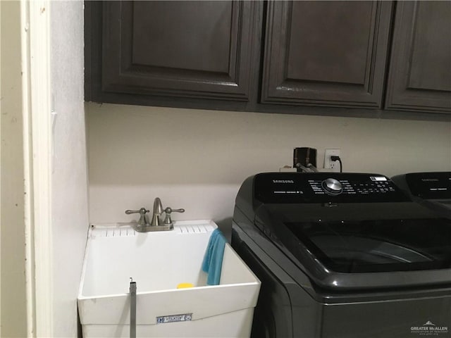 laundry room with washing machine and clothes dryer and sink