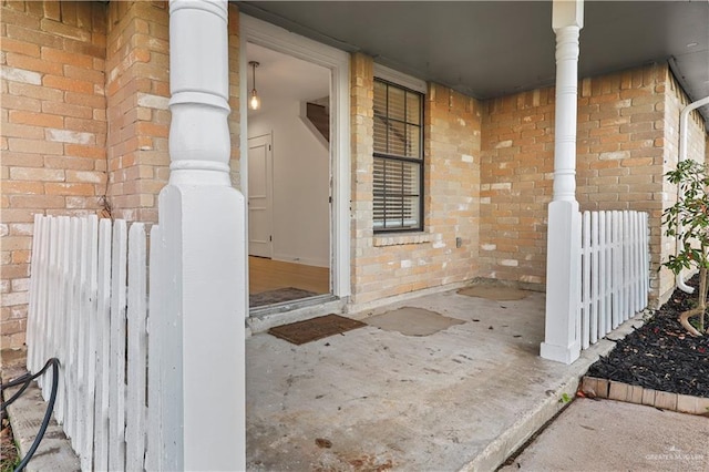 entrance to property featuring brick siding