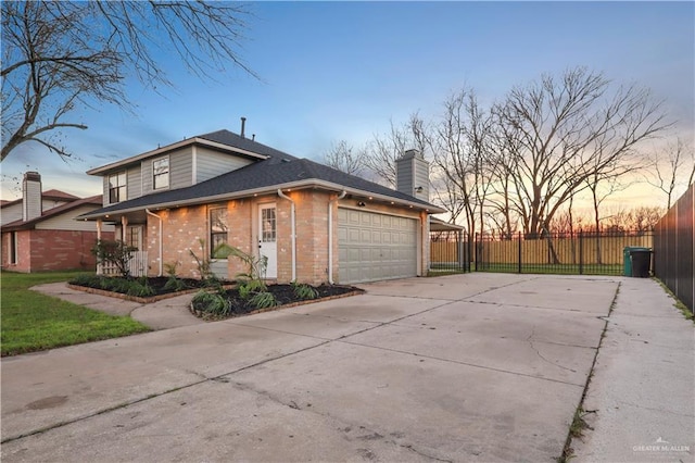 view of property exterior with driveway, fence, an attached garage, a shingled roof, and brick siding