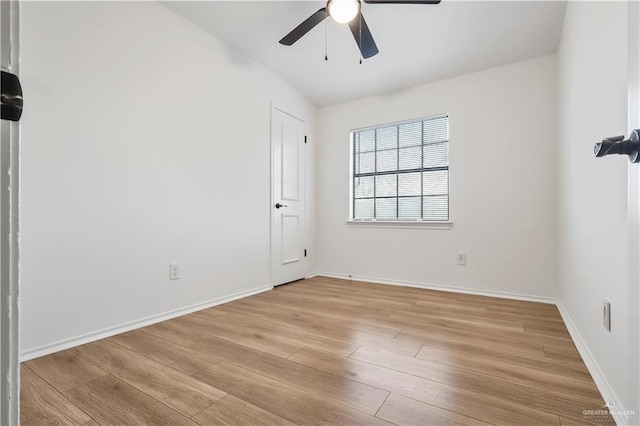 spare room with a ceiling fan, baseboards, and light wood-type flooring