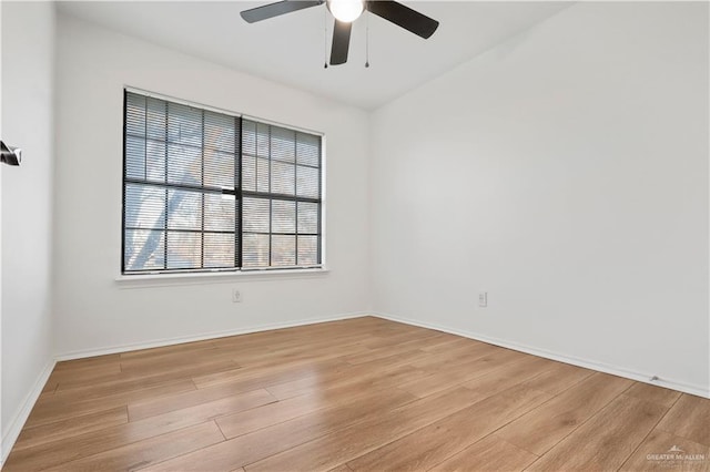 unfurnished room with baseboards, light wood-style floors, and ceiling fan