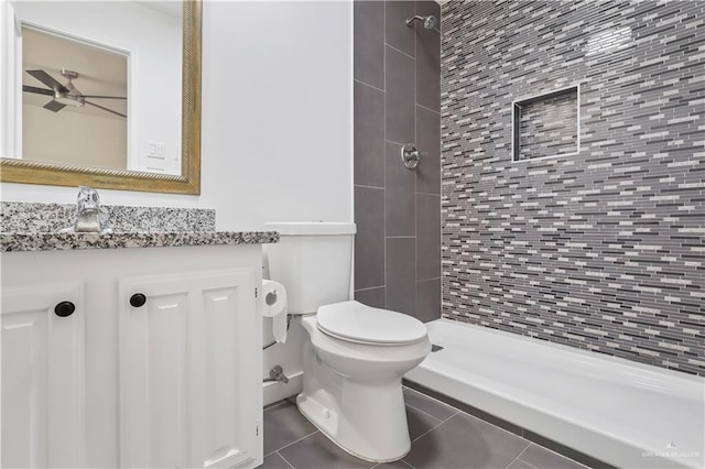 full bathroom with vanity, a shower stall, toilet, and tile patterned floors